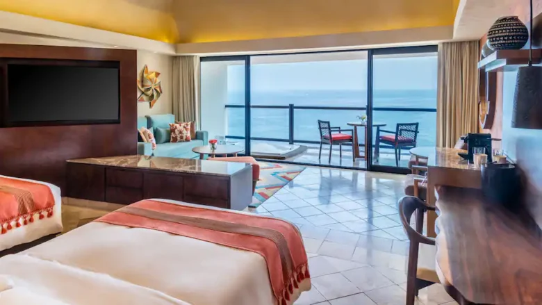 Club Oceanfront Hot Tub Double suite with two double beds, sitting area, and private ocean-view balcony at Hyatt Ziva Puerto Vallarta.