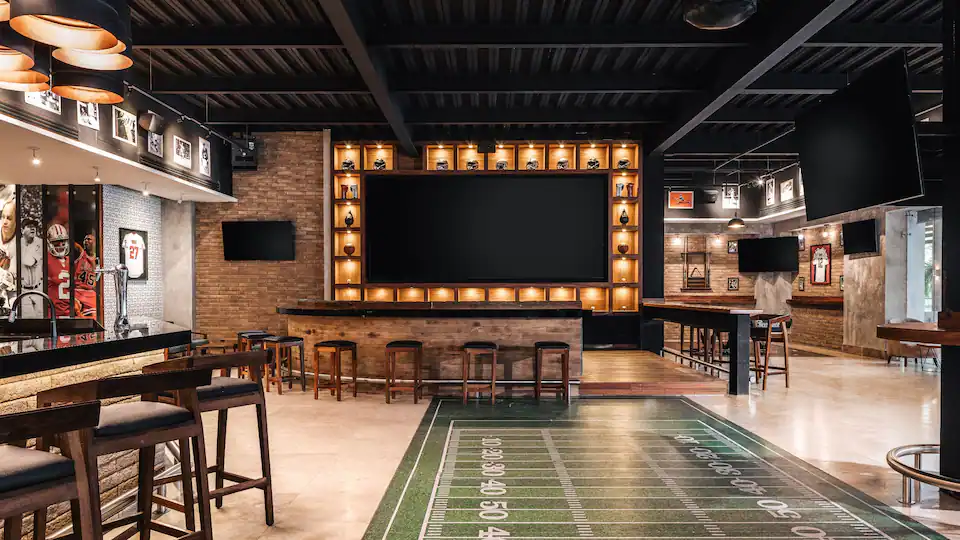 HyghlightZ Sports Bar at Hyatt Ziva Puerto Vallarta featuring multiple big-screen TVs, casual lounge seating, and a lively game-day atmosphere.