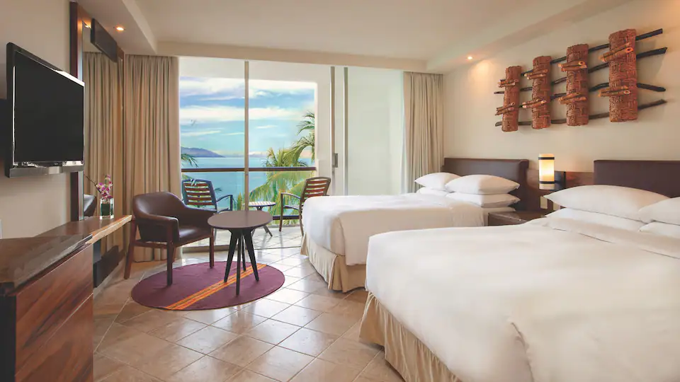 Ocean View Balcony Double room with two double beds and furnished balcony overlooking the Pacific Ocean at Hyatt Ziva Puerto Vallarta.